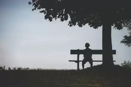 lonely boy sitting on bench