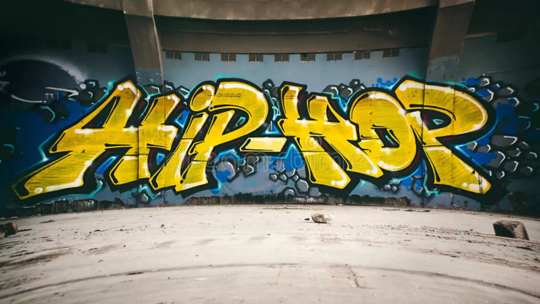 The words "hip-hop" written in graffiti on a wall.